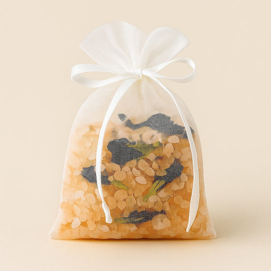 Organza pouch filled with Himalayan salt and butterfly pea flowers, tied neatly with a bow