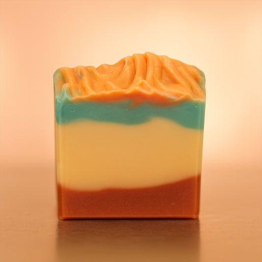 handmade soap on a warm glow light, swirled with terracotta, green and plain.