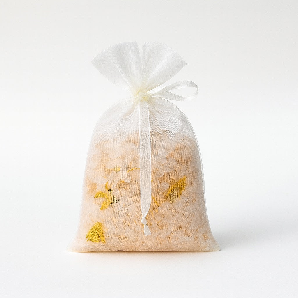 Organza drawstring bag filled with pink Himalayan salt and dried calendula petals, 