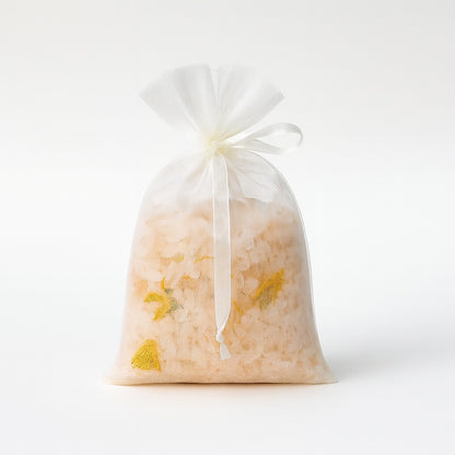 Organza drawstring bag filled with pink Himalayan salt and dried calendula petals, 