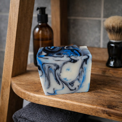 Handmade marbled soap with blue, black and cream swirls displayed on a wooden bathroom ladder shelf, country chic