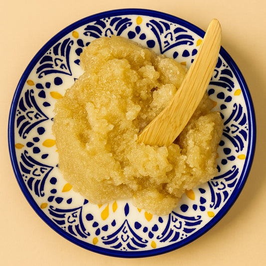 ceramic bowl with emulsified sugar scrub and wooden spatula 