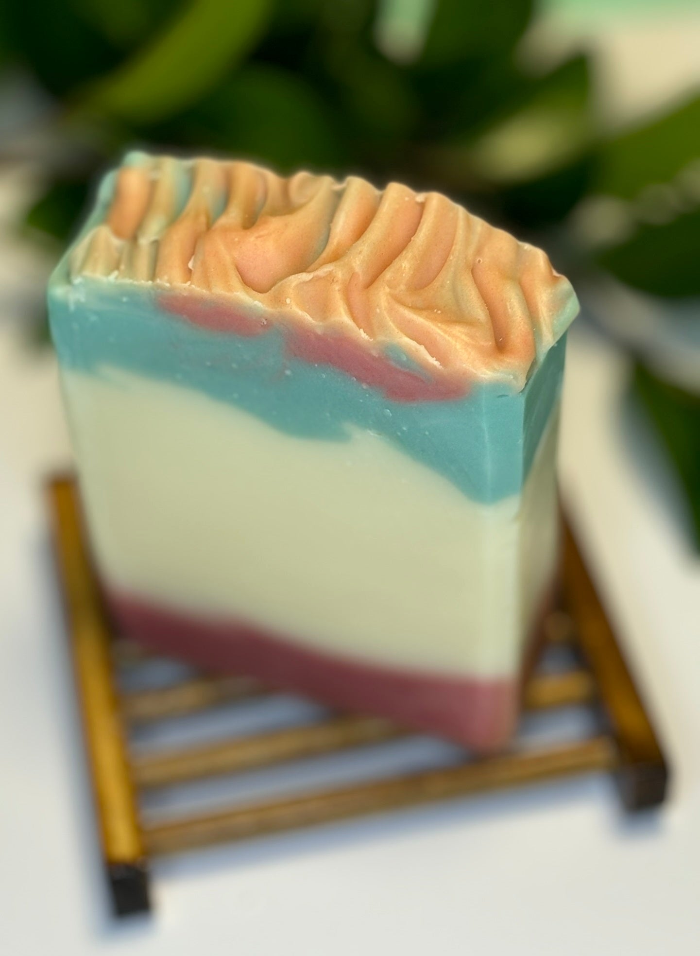 Handmade soap bar with Cedarwood and Mint, swirled with red, white, and green colours.