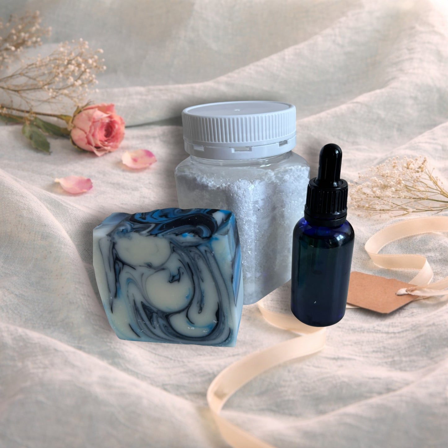bath soak, handmade soap, facial or beard oil on a valentine background with aqua linen, pink rose