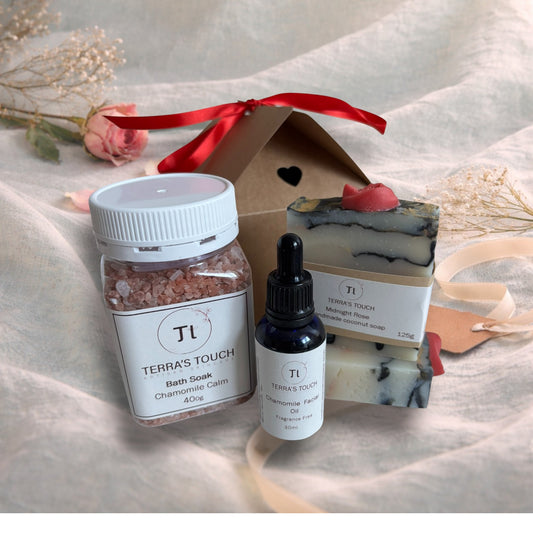 bath soak, face or beard oil and handmade soap on a valentine background with aqua linen, pink rose and craft gift box