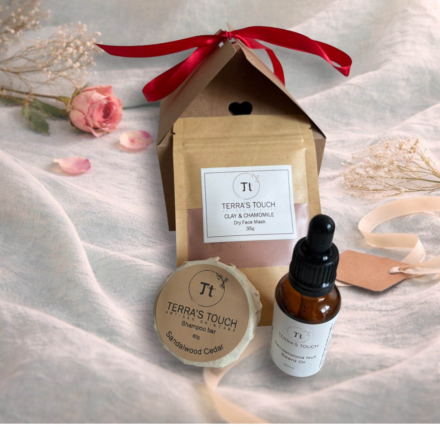 shampoo bar, dry face mask and face or beard oil on a valentine background of aqua linen , pink rose and craft gift box