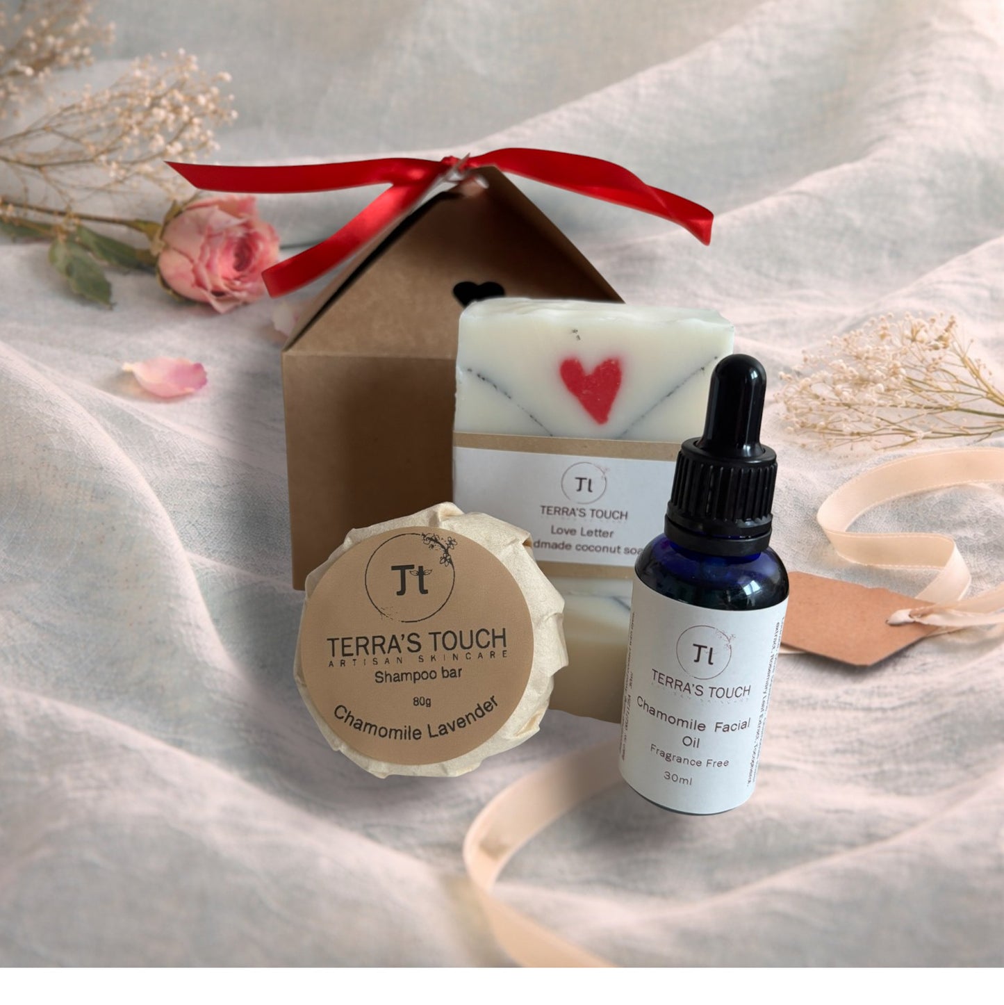 handmade soap, face or beard oil and shampoo bar on a valentine background with aqua linen, pink rose and craft gift box