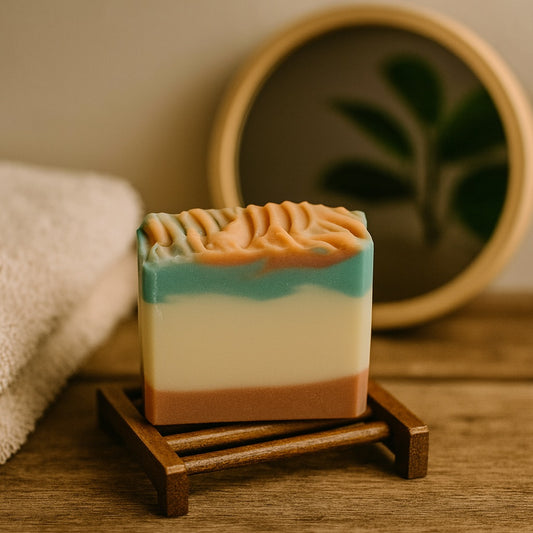 cedar frost handmade soap with green, terracotta and plain swirls on a wooden soap safer in a country chic setting