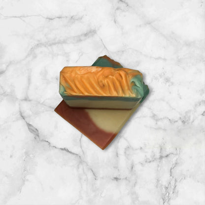 Handmade soap bar with Cedarwood and Mint, swirled with red, white, and green colours.