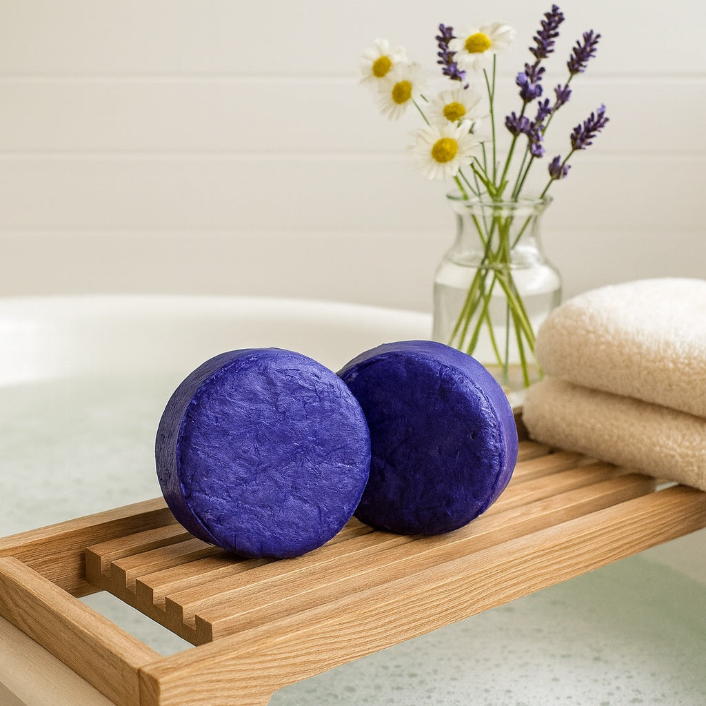 purple toning shampoo bar on a wooden bench with chamomile and lavender flowers in a vase